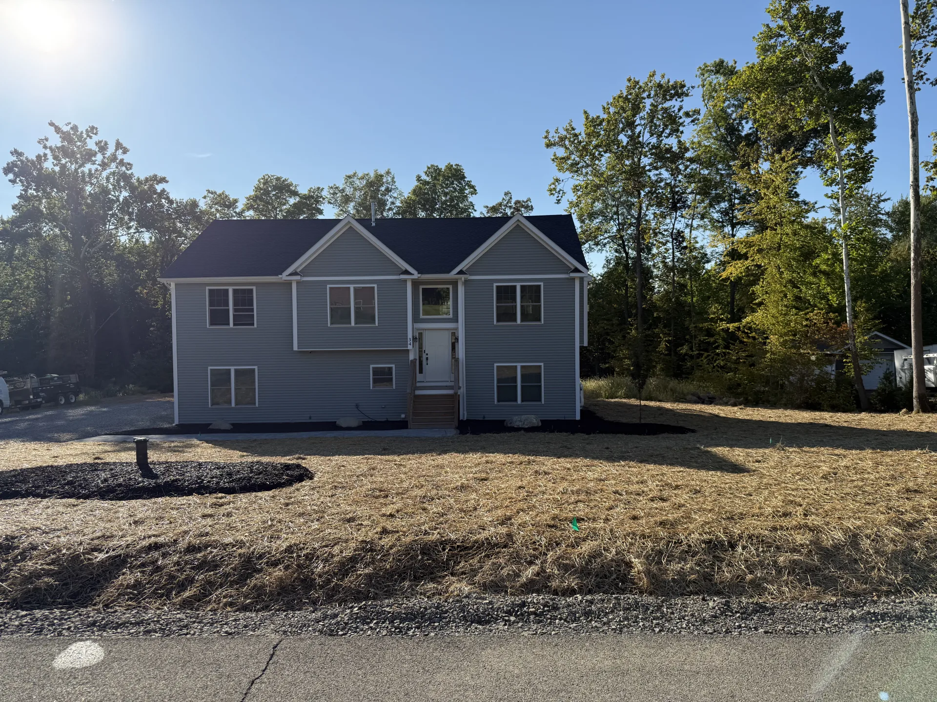 Completed front yard landscaping with mulch beds and fresh lawn by Bernicker and Son